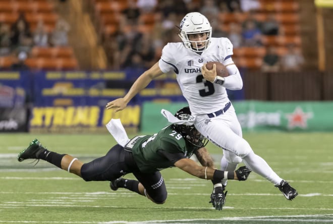 Utah State quarterback Henry Colombi (3) escapes the grasp of Hawaii defensive back Donovan Dalton (29) in the second half of an NCAA college football game, Saturday, Nov. 3, 2018, in Honolulu.