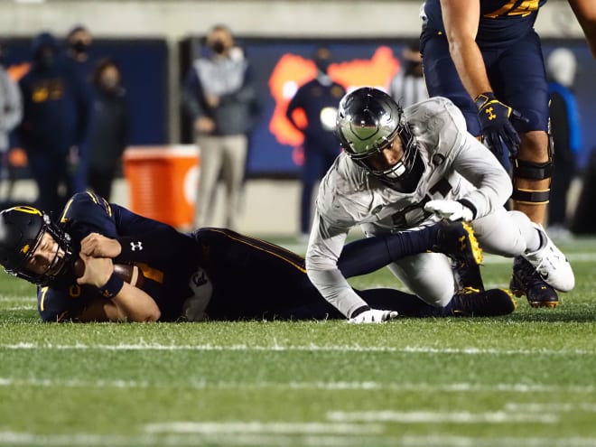 Dec 5, 2020; Berkeley, California; Oregon Ducks defensive tackle Kristian Williams (right) tackles California Golden Bears quarterback Chase Garbers (7) for a sack during the third quarter at California Memorial Stadium. 