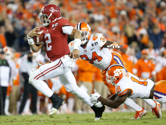 Alabama quarterback Jalen Hurts (2) runs for a touchdown as Clemson linebacker Kendall Joseph (34) and Clemson safety Jadar Johnson (18) try to tackle him during Clemson's 35-31 victory over Alabama in the College Football Playoff National Championship game in Raymond James Stadium in Tampa Monday, January 9, 2017. 