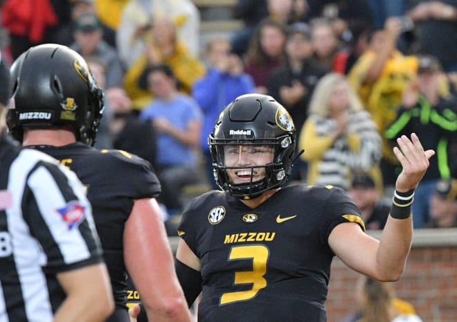 Missouri's Drew Lock, shown here thinking about all the coin coming his way in less than a year, celebrates after a touchdown against Wyoming. 