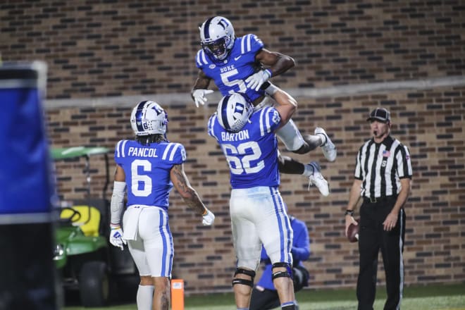 Duke receivers Eli Pancol and Jalon Calhoun, top, celebrate a touchdown last season with offensive lineman Graham Barton. 