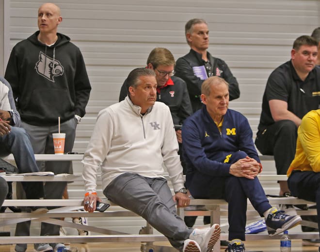 UK coach John Calipari takes in the action alongside Michigan's John Beilein. New Louisville coach Chris Mack stands in the background to the left.