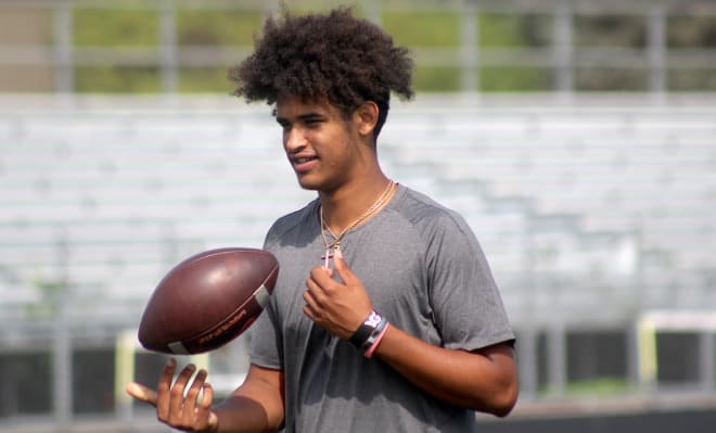 Detroit quarterback Dante Moore holds a Michigan Wolverines football recruiting offer. 