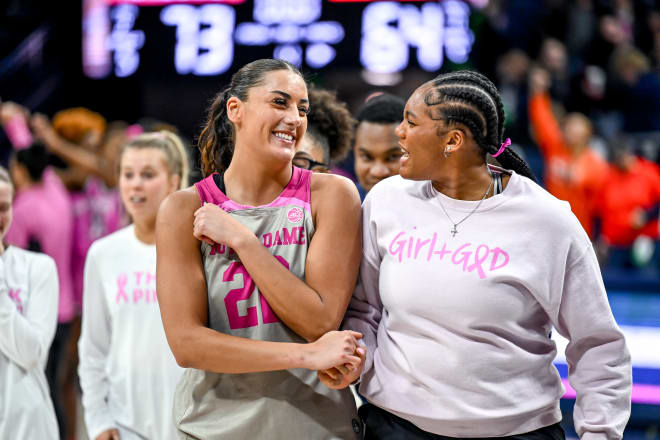 Forward Kylee Watson (left) and injured center Lauren Ebo celebrate Notre Dame's 73-64 victory over Syracuse on Sunday at Purcell Pavilion. 