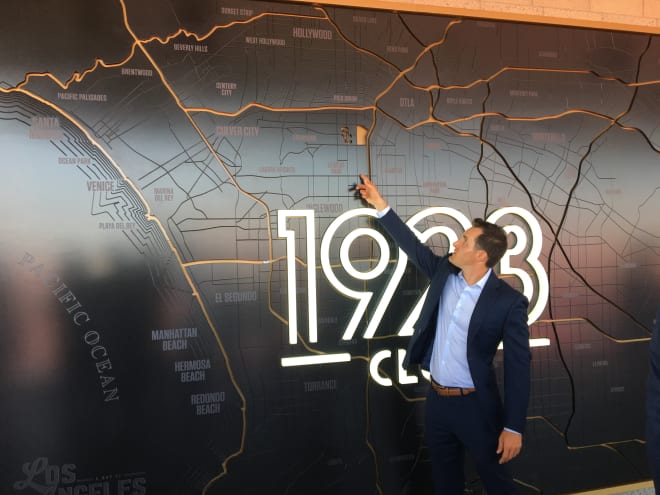 USC associate AD Jeff Fucci shows off the 1923 Club sign with a space identifying the USC campus.