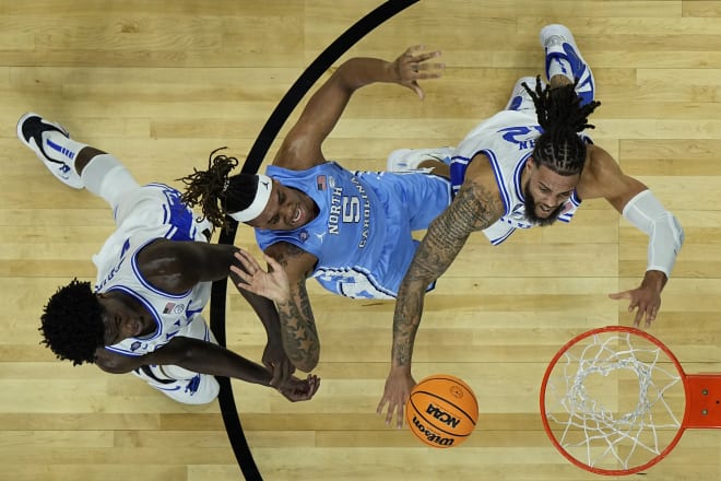 Duke forward Theo John, right, battles North Carolina forward Armando Bacot on Saturday night. 