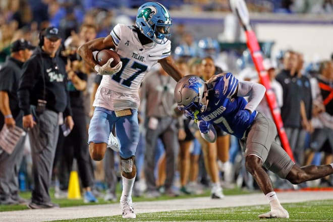 Oct 13, 2023; Memphis, Tennessee, USA; Tulane Green Wave wide receiver Chris Brazzell II (17) runs after a catch as Memphis Tigers defensive back Malik Feaster (7) knocks him out of bounds during the first half at Simmons Bank Liberty Stadium. 