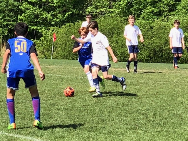 Carson (in white) on the attack Sunday morning at the Mike Rose Soccer Complex in Memphis. Carson's North Mississippi Soccer Academy team won, 3-2.
