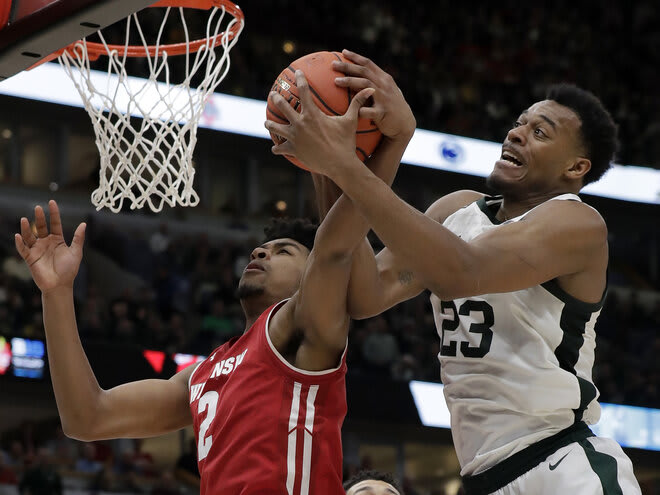 Wisconsin's Aleem Ford (2) and Michigan State's Xavier Tillman (23) battle for a rebound during the 2019 Big Ten tournament. MSU outrebounded UW by 14 and won by 12.