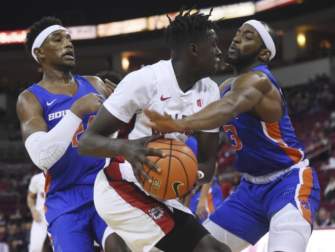 Fresno State's Aguir Agau, center, with Boise State's Abu Kigab, left, and Boise State's RJ Williams, right, battle for the ball during an NCAA college basketball game, Saturday, Jan. 25, 2020 in Fresno, Calif.