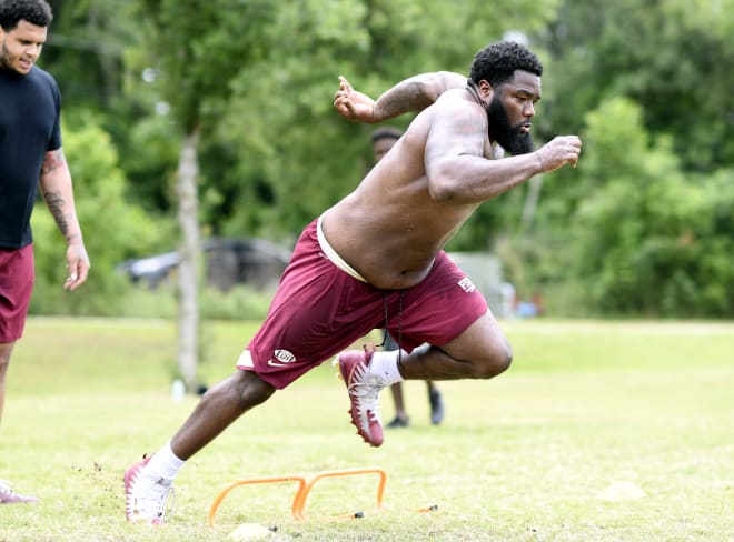 FSU defensive tackle Marvin Wilson runs through drills at a Tallahassee park last week, as teammate Cory Durden looks on.