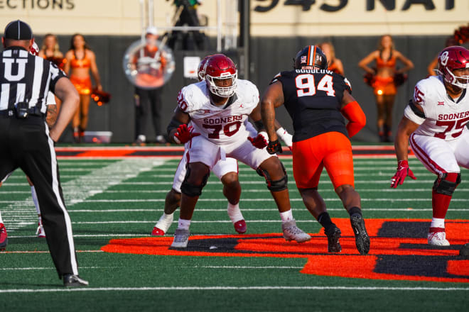 Green takes a snap in pass protection against Oklahoma State's Anthony Goodlow