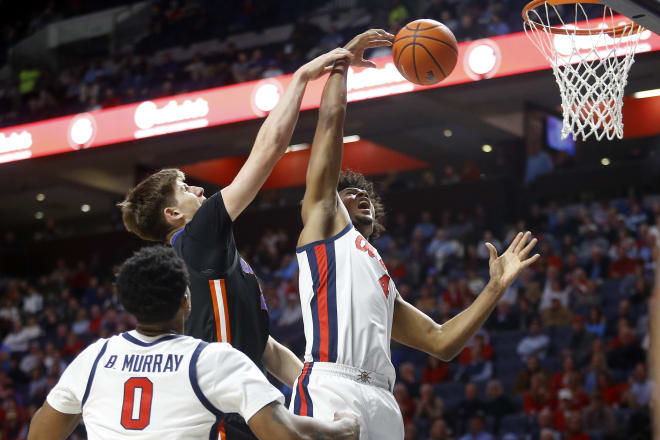 Florida Gators forward/center Alex Condon (21) and Ole Miss Rebels forward Jaemyn Brakefield (4) battle for a rebound during the first half at The Sandy and John Black Pavilion at Ole Miss. Mandatory Credit: Petre Thomas-USA TODAY Sports