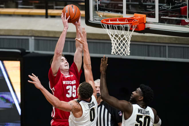 Wisconsin forward Nate Reuvers (35) shoots over Purdue forwards Mason Gillis (0) and Trevion Williams (50) during the second half.