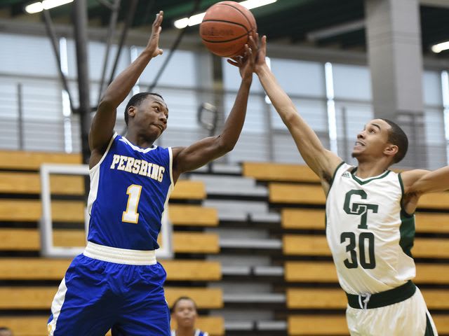Pershing's Charles Brown and Cass Tech's Marcus Gibbs going for a rebound.