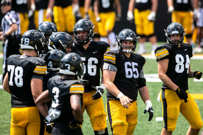 Iowa center Tyler Linderbaum (65) smiles while huddling up with teammates during Hawkeyes football Kids Day at Kinnick open practice, Saturday, Aug. 14, 2021, at Kinnick Stadium in Iowa City, Iowa. 2... Joseph Cress/Iowa City Press-Citizen-Imagn Content Services, LLC