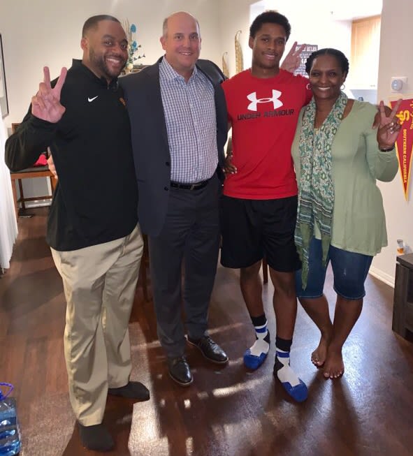 USC WRs coach Keary Colbert and head coach Clay Helton visit with Munir McClain and his mother Shan in December.