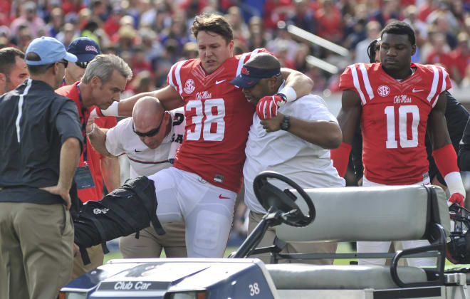 Medical personnel help Ole Miss defensive end John Youngblood to the cart after he suffered a season-ending injury in the Rebels' win over Georgia Southern Saturday.
