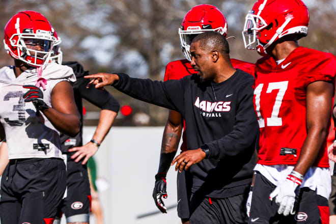 Wide receiver coach Brian McClendon makes a point during practice.