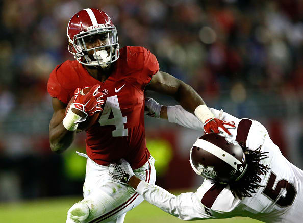 TUSCALOOSA, AL - NOVEMBER 15: T.J. Yeldon #4 of the Alabama Crimson Tide stiff arms Jamerson Love #5 of the Mississippi State Bulldogs at Bryant-Denny Stadium on November 15, 2014 in Tuscaloosa, Alabama. (Photo by Kevin C. Cox/Getty Images)