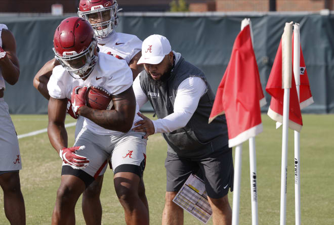 Alabama running backs coach Robert Gillespie, right, goes through drills with players. Photo | Alabama Athletics 