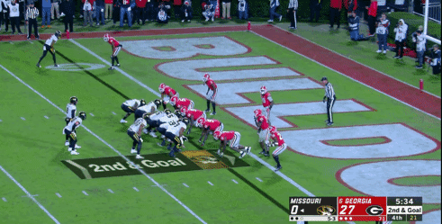 Rice rushes the edge near the goal line.