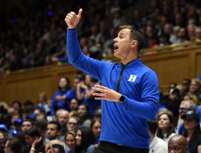 Jon Scheyer makes a call during Duke's game on Friday night. 