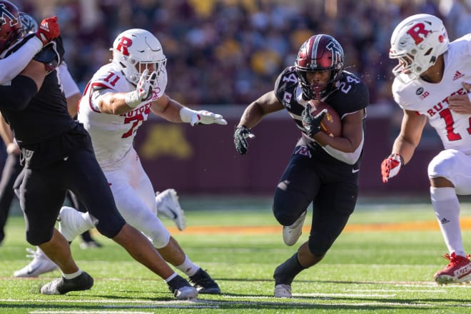 Oct 29, 2022; Minneapolis, Minnesota, USA; Minnesota Golden Gophers running back Mohamed Ibrahim (24) evades Rutgers Scarlet Knights defensive lineman Aaron Lewis (71) in the first quarter at Huntington Bank Stadium.