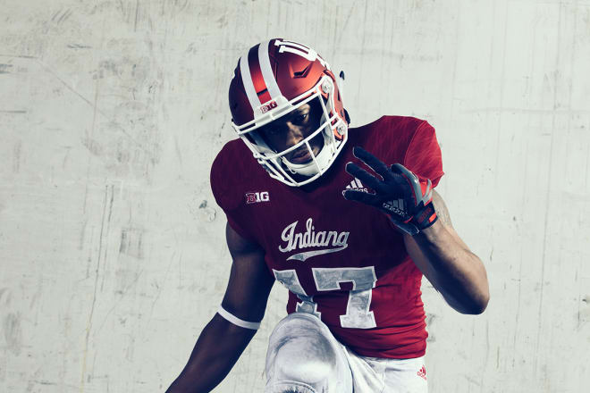 The crimson helmet has a white interlocked “IU” logo on the sides and features the familiar candy stripe pattern.
