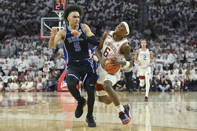 Arkansas guard Layden Blocker is fouled by Duke guard Tyrese Proctor.