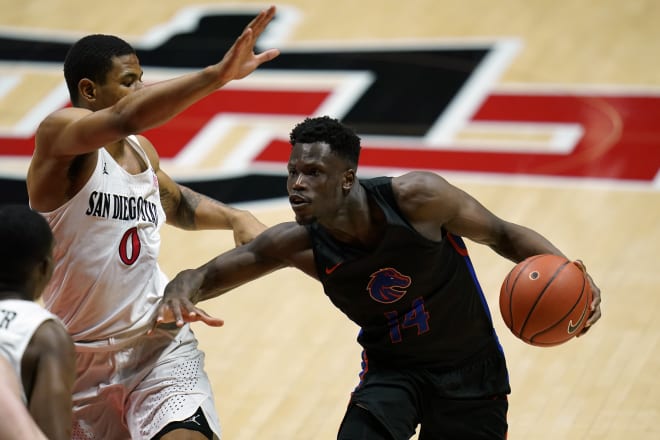 Boise State guard Emmanuel Akot (14) controls the ball against San Diego State forward Keshad Johnson (0) during the second half of an NCAA college basketball game Thursday, Feb. 25, 2021, in San Diego.