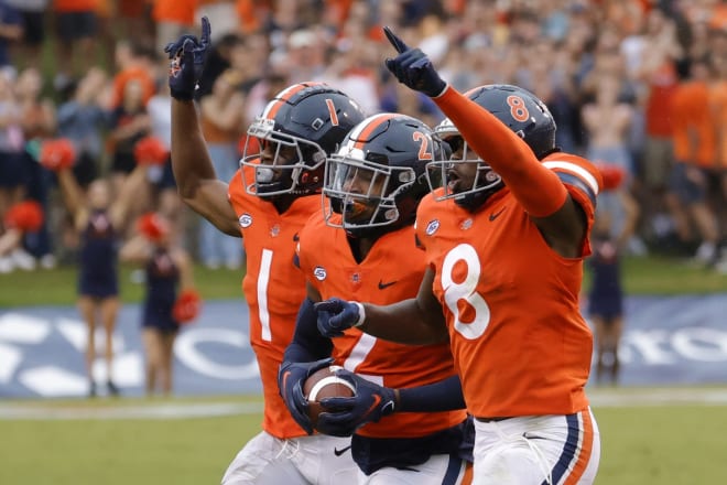 Virginia's De'Vante Cross, middle, celebrates with teammates during the Cavaliers' blowout of visiting Duke. 