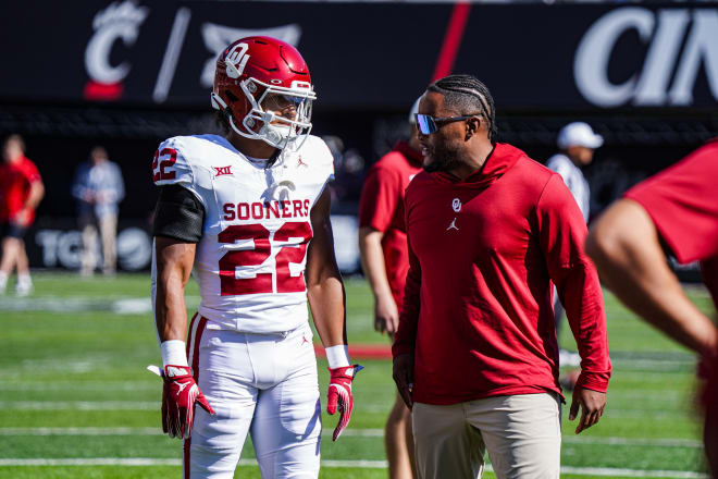 Oklahoma safety Peyton Bowen converses with defensive assistant Xavier Brewer