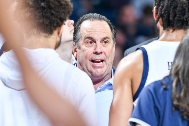 Notre Dame men's basketball head coach Mike Brey with his team during a game