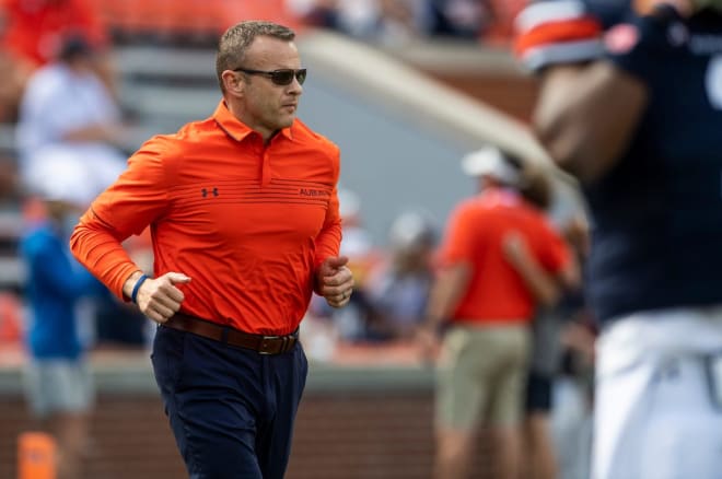 Bryan Harsin runs onto the field at Jordan-Hare Stadium.