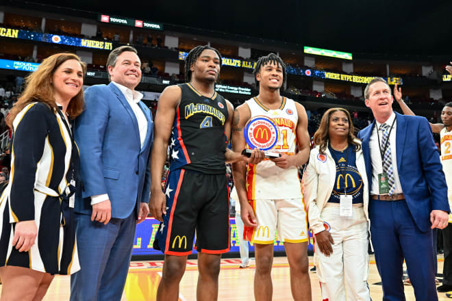 D.J. Wagner, fourth from left, poses with the MVP trophy with Isaiah Collier, third from left. 