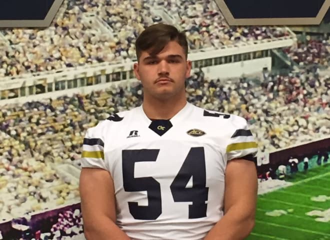 Andrews poses in a Georgia Tech jersey during his visit to the Flats