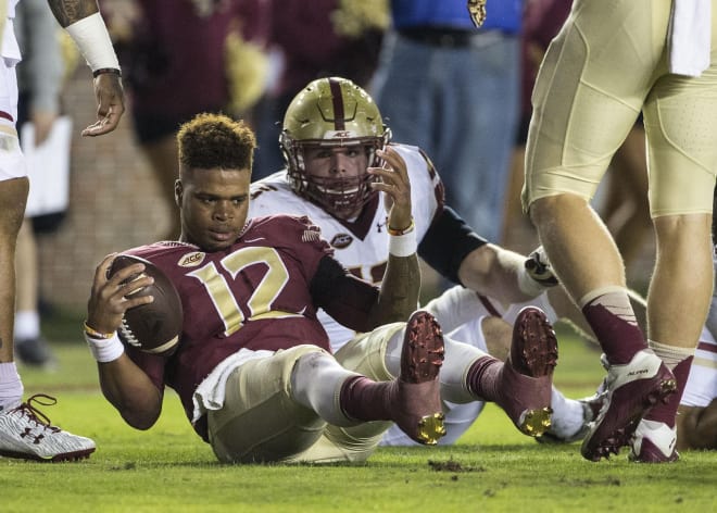 Florida State Seminoles quarterback Deondre Francois (12) has his helmet knocked off during a first quarter run against the Boston College Eagles at Doak Campbell Stadium. Photo | USA Today