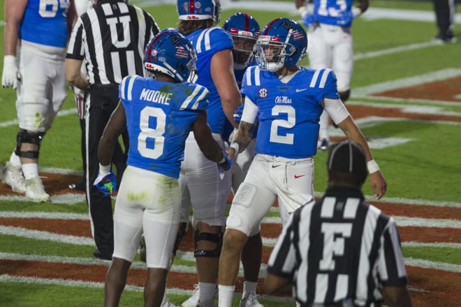 Ole Miss quarterback Matt Corral (2) celebrates with wide receiver Elijah Moore after a first-half touchdown Saturday night.