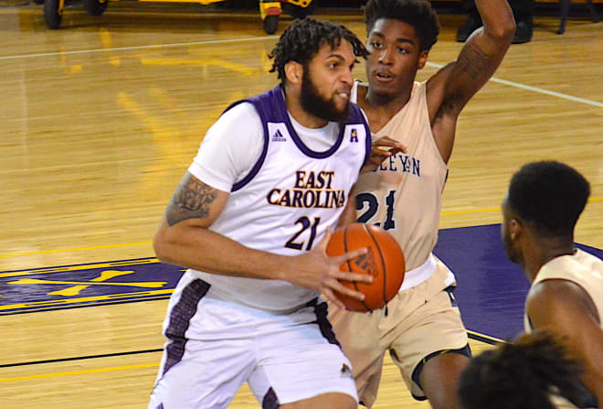 ECU center Ludgy Debaut drives on N.C. Wesleyan's Isaiah Lewis in Tuesday night's game in Greenville.