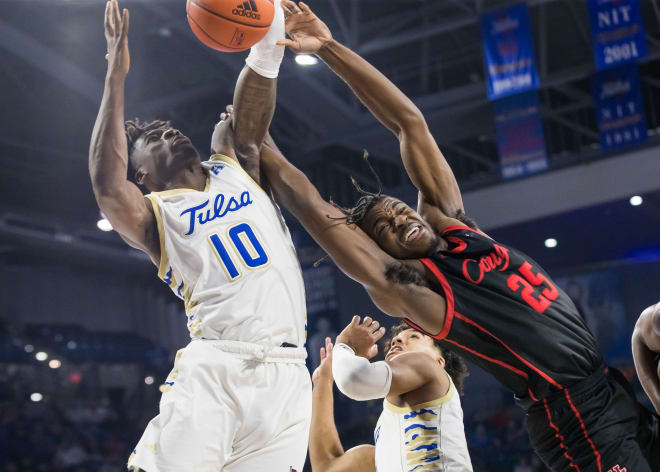 Tulsa's Tim Dalger fights for a rebound against Houston.