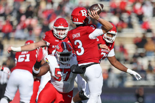 Nov 27, 2021; Piscataway, New Jersey, USA; Maryland Terrapins defensive lineman Isaac Bunyun (57) hits Rutgers Scarlet Knights quarterback Evan Simon (3) while throwing the ball during the first half at SHI Stadium.