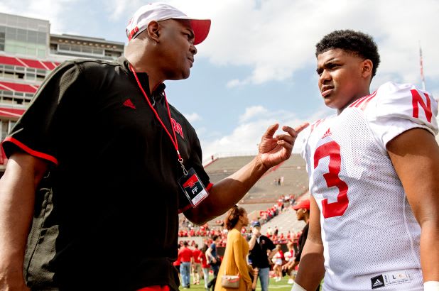 Keyshawn Johnson Sr. talks to his son Keyshawn Johnson Jr. during the 2017 Red-White game. 