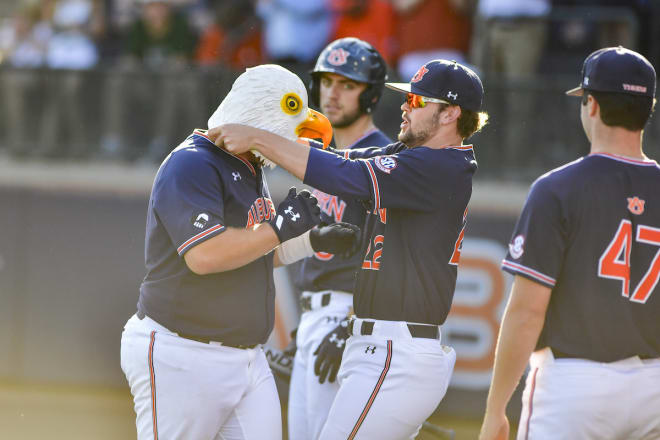 Sonny DiChiara puts on the eagle mask after hitting a homer.