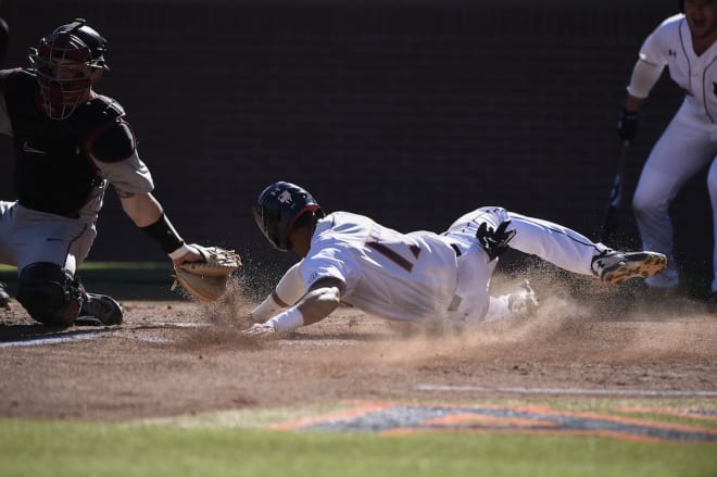 Holland slides in safe at home in the second inning.