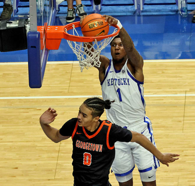 Kentucky freshman Justin Edwards soared to dunk over Georgetown College's Cam Brook-Harris during Friday's exhibition game at Rupp Arena.