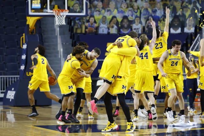 Michigan players kick off the wild celebration after routing Michigan State for the Big Ten title.