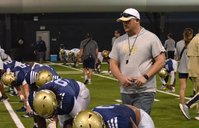 Brent Key monitors his players during flex on day one of full pads