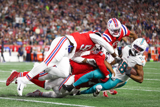 Sep 17, 2023; Foxborough, Massachusetts, USA; The New England Patriots defense tackles Miami Dolphins receiver Erik Ezukanma (18) during the first half at Gillette Stadium.