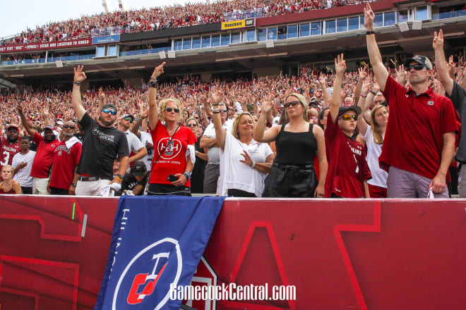 South Carolina fans hold up three fingers for mental health awareness.